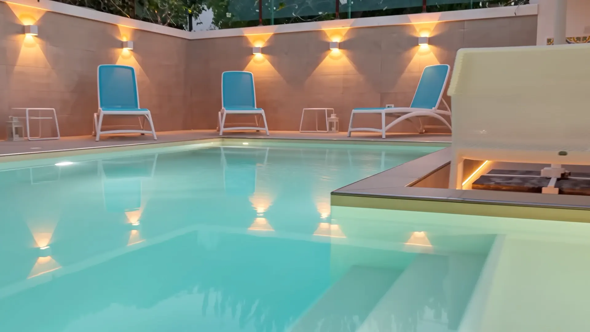 The illuminated water of the pool at Villa Vera
